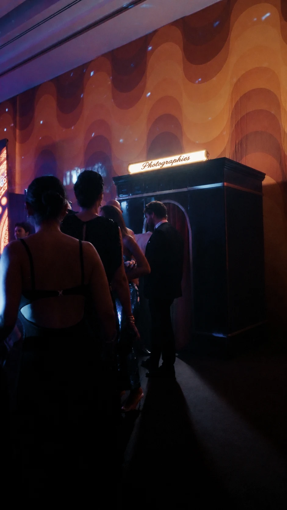 Guests at an evening event with The Archive photo booth